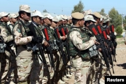 FILE - Kurdish Peshmerga fighters take part during a training session by coalition forces in a training camp in Irbil, north of Iraq, March 9, 2016.