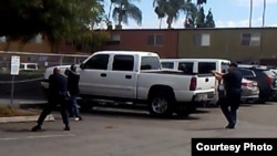 FILE - Police are seen confronting a man in a "shooting stance" El Cajon, California, Sept. 27, 2016.