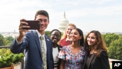 The newly-appointed 2017 Class of National Student Poets, from left, Ben Lee, Juliet Lubwama, Annie Castillo, Kinsale Hueston, and Camila Sanmiguel celebrate with a selfie on the rooftop balcony at the Library of Congress on Thursday, Aug. 31, 2017.