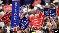 Signs are passed out to delegates during the evening session of the opening day of the Republican National Convention in Cleveland, July 18, 2016.