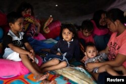 A family affected by the earthquake and tsunami is pictured at a temporary shelter in Donggala, Central Sulawesi, Indonesia Oct. 3, 2018.