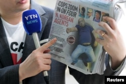 부검을 위해 김정남 시신이 안치돼 있는 말레이시아 쿠알라룸푸르 병원 영안실 앞에서 지난달 18일 기자가 피습 직후 공항 진료소에서 쓰러진 김정남의 사진이 표지에 실린 현지 신문을 들고 있다.