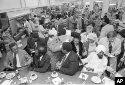 Former North Carolina A & T students, left to right, Joseph McNeill, David Richmond, Franklin McCain and Jibreel Khazan, are shown at the F.W. Woolworth lunch counter in Greensboro, N.C., Feb. 1, 1980.
