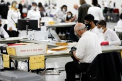 Detroit election workers work on counting absentee ballots for the 2020 general election at TCF Center on November 4, 2020 in Detroit, Michigan.