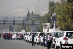 A convoy consisting of Red Cross, Red Crescent and United Nation (UN) gather before heading towards to Madaya from Damascus, and to al Foua and Kefraya in Idlib province, Syria, Jan. 11, 2016.