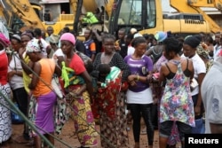 FILE - Victims of the August mudslide are gathered in a queue at an internally displaced persons camp in Regent, Sierra Leone, Aug. 21, 2017.