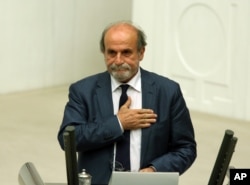 Ertugrul Kurkcu, a former leftist guerrilla and a newly elected legislator from pro-Kurdish Peoples's Democracy Party, takes his oath during the Turkish parliament’s first session in Ankara, Turkey, June 23, 2015.