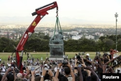 Students cheer as the statue of Cecil John Rhodes is removed from the University of Cape Town (UCT) in South Africa, April 9, 2015.