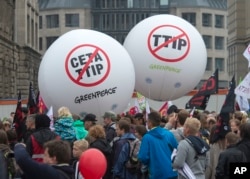FILE - People demonstrate against the TTIP and CETA trade agreements in Leipzig, Germany, Sept. 17, 2016. Thousands of people are rallying in cities across Germany to protest against planned European Union trade deals with the United States and Canada.