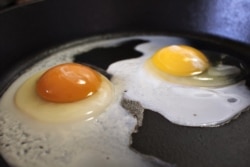 These are eggs frying in a pan.