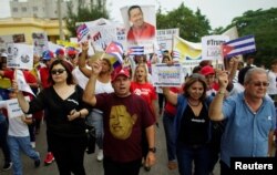 People shout slogans during a march to express support for Venezuela in Havana, Cuba, Aug. 25, 2017.