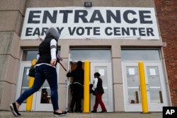 FILE - Voters arrive to vote early at the Franklin County Board of Elections, Oct. 31, 2018, in Columbus, Ohio.