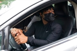Food bank patron Renada James picks up food in her car to help feed her grandchildren and nieces, at a food bank in Washington, Oct. 6, 2021.