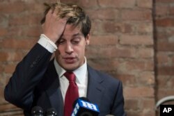 Milo Yiannopoulos gestures during a news conference, Feb. 21, 2017, in New York. Yiannopoulos has resigned as editor of Breitbart Tech after coming under fire from other conservatives over comments on sexual relationships between boys and older men.