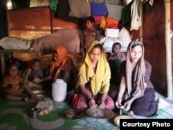 Noor Ankis, the mother of Rohingya sisters Johora (in yellow scarf), 12, and Jannatara, 14, finds it difficult to feed her family with the food rations she gets and plans to marry off her underage daughters as soon as possible. (Photos by Noor Hossain)
