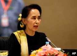 FILE - Myanmar's State Counsellor Aung San Suu Kyi speaks to members of the Union Peace Dialogue Joint Committee (UPDJC) on its ninth meeting at a hotel in Naypyitaw, Myanmar, Feb. 6. 2017.