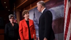 Sen. Jeanne Shaheen, D-N.H., center, and Sen. Joni Ernst, R-Iowa, left, talk with Sen. Thom Tillis, R-N.C., right, on Capitol Hill in Washington, Feb. 7, 2018,