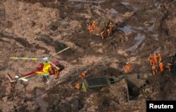 Rescue crew work in a tailings dam owned by Brazilian miner Vale SA that burst, in Brumadinho, Brazil Jan. 25, 2019.