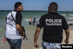 Tourist police officers patrol at the beach in Sousse, Tunisia, July 1, 2015.