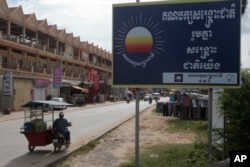 FILE - A signboard logo of the opposition Cambodia Rescue Party sticks on a sidewalk at the outskirts of Phnom Penh, Cambodia, Oct. 6, 2017. Cambodia's government has taken the initial legal steps to dissolve the country's major opposition party.