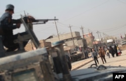 Iraqi forces patrol the Hammam al-Alil area, about 14 kilometres from the southern outskirts of Mosul, on Nov. 7, 2016, after recapturing it from Islamic State jihadists during the ongoing operation to retake Mosul.