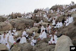 FILE - Muslim pilgrims gather to pray at Jabal al-Rahma holy mountain, or the mountain of forgiveness, during the annual pilgrimage, near Mecca, Saudi Arabia, Oct. 3, 2014.