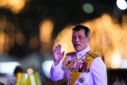 FILE - Thailand's King Maha Vajiralongkorn greets royalists ahead of a candlelight vigil to remember the birthday of Thailand's late King Bhumibol Adulyadej, outside the Grand Palace in Bangkok, Thailand, Dec. 5, 2020.