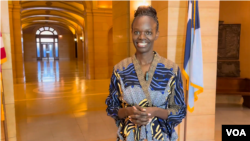 Huldah Momanyi Hiltsley akizungumza kutoka ndan i ya jengo la bunge la Minnesota.