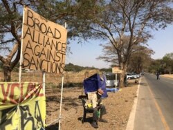 Members of a pro-Zimbabwe government group called Broad Coalition Against Sanctions have been camped outside the U.S. Embassy in Harare, demanding the sanctions be lifted, Aug. 20, 2019. They say sanctions hurt ordinary citizens. (C. Mavhunga/VOA)