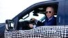 President Joe Biden stops to talk to the media as he drives a Ford F-150 Lightning truck at Ford Dearborn Development Center, in Dearborn, Mich., May 18, 2021.