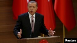 FILE - Turkish President Recep Tayyip Erdogan makes a speech at the Presidential Palace in Ankara, Nov. 26, 2015. Ankara summoned the American ambassador, John Bass, on Feb. 9, 2016, to protest remarks by a State Department spokesman who said Washington does not consider Syria's Kurdish Democracy Union Party (PYD) a terrorist organization.