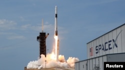 A SpaceX Falcon 9 rocket and Crew Dragon spacecraft carrying NASA astronauts Douglas Hurley and Robert Behnken lifts off during NASA's SpaceX Demo-2 mission to the International Space Station from NASA's Kennedy Space Center in Cape Canaveral, Florida, U.S., May 30, 2020. REUTERS