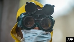 A cleaner wears protective gear to disinfect public transit as a preventive measure against the spreading of the COVID-19 coronavirus in Addis Ababa, Ethiopia, on March 20, 2020.