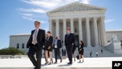 People leave the Supreme Court in Washington, June 26, 2017, as justices issued their final rulings for the term.