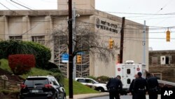 FILE - First responders stand outside the Tree of Life Synagogue in Pittsburgh, Oct. 27, 2018. 