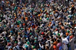 Farmers shout slogans during a protest against the newly passed farm bills at Singhu border near Delhi, India, Dec. 3, 2020.