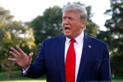 FILE - President Donald Trump speaks to members of the media on the South Lawn of the White House in Washington, Oct. 10, 2019, before boarding Marine One.