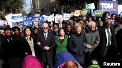 FILE - Democratic presidential rivals Tulsi Gabbard, Joe Biden, Amy Klobuchar, Elizabeth Warren and Bernie Sanders link arms during a Martin Luther King Jr. Day march, Jan. 20, 2020, in Columbia, South Carolina.