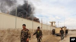 FILE - Smoke rises from a building, where Taliban insurgents hide during a firefight with Afghan security forces, in Helmand province, southwest Afghanistan, March 9, 2016.