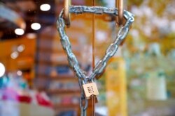 FILE - A business is chained and padlocked on the first day of a five-day lockdown implemented in the state of Victoria in response to the coronavirus disease (COVID-19) outbreak in Melbourne, Australia, Feb. 13, 2021.