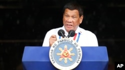 FILE - Philippine President Rodrigo Duterte gestures while addressing the crowd at the 120th Philippine Independence Day celebration, June 12, 2018. Duterte pressed congress to pass the Bangsamoro Organic Law.