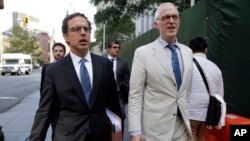 Carmine Boccuzzi, foreground left, a lawyer representing Argentina, leaves Federal court after a hearing, in New York, Aug. 21, 2014.