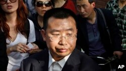 FILE - Human rights activist Jiang Tianyong speaks to journalists in Beijing, China, May 2, 2012. Jiang detained in connection with a sweeping crackdown on lawyers and activists stood trial Aug. 22, 2017, on charges of subversion of state power.