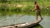 A fisherman catches a fish in Peamror district, Prey Veng province, Cambodia, on July 22, 2020. (Aun Chhengpor/VOA Khmer)