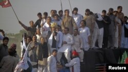 Pakistan Tehreek-e-Insaf (PTI) head Imran Khan, wearing a traditional turban, speaks to supporters during a peace march against U.S. drone strikes from Islamabad to South Waziristan, in Pakistan's northwestern town of Tank October 7, 2012.