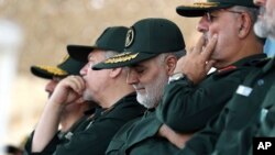 Gen. Qassem Soleimani, center, who heads the elite Quds Force of Iran's Revolutionary Guard attends a graduation ceremony of a group of the guard's officers in Tehran, Iran, June 30, 2018.