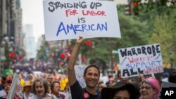 FILE- Local 764 Wardrobe union member Andrae Gonzalo marches in the annual Labor Day Parade in New York.
