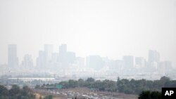Haze hangs in the air over downtown Denver, July 24, 2024. Fires burning in western states, as well as Canada, have filled the skies with smoke and haze, forcing some affected areas to declare air quality alerts or advisories. 