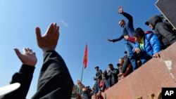 People protest during a rally on the central square in Bishkek, Kyrgyzstan, Oct. 7, 2020. Officials in Kyrgyzstan have nullified the results of a weekend parliamentary election after mass protests erupted in Bishkek and other cities.
