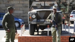 FILE - Army personnel are seen outside the military headquarters in Maseru, Lesotho, Aug. 31, 2014.
